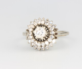 An 18ct white gold diamond cluster ring 4.1 grams, size M 1/2, the centre stone 0.4ct surrounded by brilliant cut stones