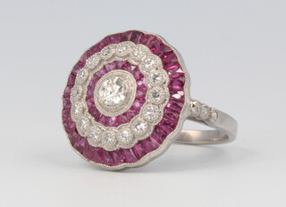 A Victorian style platinum, diamond and ruby target ring, size M 1/2, 7.5 grams
