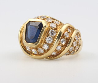 A yellow metal sapphire and diamond ring, the 42 brilliant cut diamonds approx. 1.5ct, the tapered sapphire approx. 8mm, tapering from 8mm to 6mm size N, 14.2 grams gross 