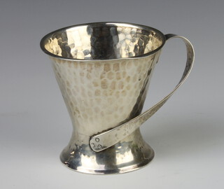 A Edwardian Arts and Crafts silver hammered pattern tapered mug with fancy handle London 1906 8cm, 118 grams 
