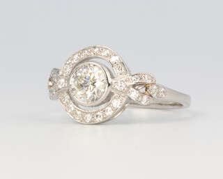 A platinum Art Deco style diamond target ring, centre stone 0.3ct, the remaining brilliant cut diamonds 0.3ct, size N, 4.3 grams 