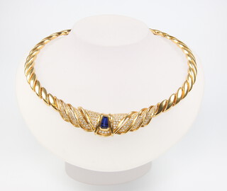 A yellow metal (stamped 750) diamond and sapphire twist necklace containing 238 brilliant cut diamonds, approx. 2ct and a tapered blue sapphire 6mm wide x 9mm deep tapering to 4mm, 100 grams gross 