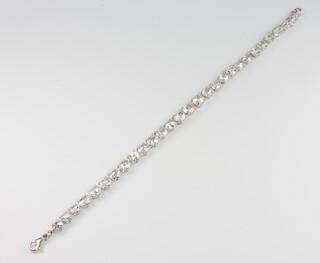 A good white metal (stamped 750) 29 stone oval mine cut diamond bracelet, approx. 13ct, 18.5cm, 12.5 grams, 27 stones are set upside down 