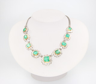 A white metal emerald and diamond necklace set with 10 cushion cut emeralds approx. 8ct and 132 brilliant cut diamonds approx. 8ct, 36.5cm, 43 grams 