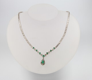 A white metal (stamped 750) emerald and diamond necklace comprising 1 pear cut emerald and 7 brilliant cut emeralds, approx. 1ct, together with 19 brilliant cut diamonds approx. 0.25ct, 31 grams, 40cm 