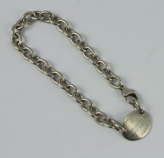 A silver bracelet with oval panel, marked Please return to Tiffany, 26 grams