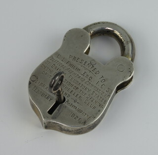 A white metal padlock and key inscribed 1926 8.5cm
