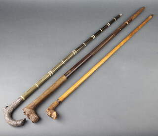 An Indian white metal handled walking cane with bone inlay, a ditto with a hound head handle and 1 with a hippopotamus handle 