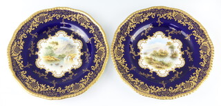 A pair of Coalport decorative plates, the blue and gilt rims enclosing views of "Lagra Charta, Ireland" signed C O Bull, another "Mount Vernon, Perthshire" 23cm diam