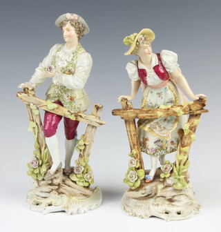 A pair of Continental 19th Century porcelain figures of a lady and gentleman at a gate, raised on Rococo bases 22cm