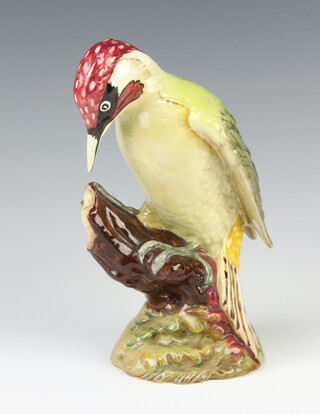 A Beswick Woodpecker, number 1218, standing on a stump 22cm 