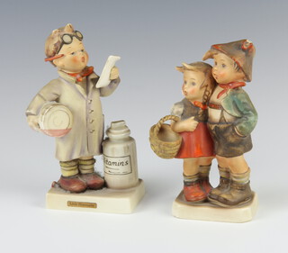 A Hummel figure "Little Pharmacist" no 322, 14cm, together with a Hummel figure of a boy and girl carrying a basket, no 94/1, 13cm