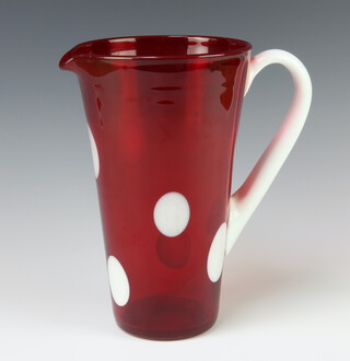 A 1960's red glass jug with white spots and handle 24cm 