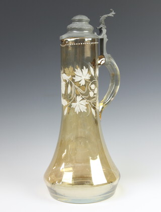 A Continental lustre claret jug with painted white floral decoration and pewter mounts 40cm 