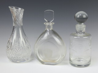 A Orrefors flattened spirit decanter and stopper with engraved pail 25cm, a circular ditto 23cm and a baluster vase 25cm 
