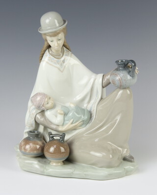 A Lladro group of a reclining lady with baby and water carrier 22cm 