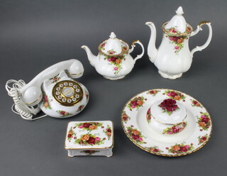 A Royal Albert Old Country Roses tea, coffee and dinner service, comprising coffee pot (second), teapot, 8 soup plates, 8 dinner plates, 6 tea cups, 6 saucers, 4 coffee cups, 12 saucers, sugar bowl, 8 side plates, 6 small plates, bowl and lid, a rectangular box and lid, milk jug, rectangular dish, 2 handled cup, salt and pepper, 11 napkin rings together with a Royal Albert telephone and 2 napkin rings  