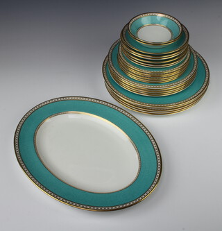 A set of Wedgwood tableware with turquoise bands and gilt rims comprising 2 shallow dishes, 6 saucers, 6 small plates, 5 dessert plates, 5 dinner plates and an oval serving plate 