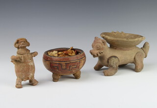 A pre-Colombian style earthenware figure of a dish supported by a mythical beast 18cm, ditto rattle in the form of a standing figure 12cm together with a bowl with geometric decoration 12cm 