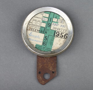 A 1950's Raydyot glass and metal tax disc holder containing 6 tax discs for Cycle Mini Motor Master 1953 (x2), Bicycle Mini Motor 1954, Cycle Mini Motor 1954, Bicycle Mini Motor 1955 and Bicycle Mini Motor 1956 