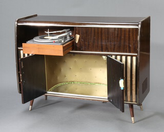 An Arkansas deluxe stereogram 43942 fitted Garrard turntable and Blaupunkt Radiogram behind slide doors, the base fitted a drinks cabinet.