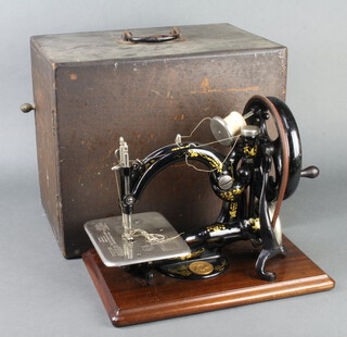 A Willcox & Gibbs sewing machine complete with carrying case 