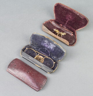 A pair of gilt metal pince nez contained in a G C Bateman opticians case, 1 other pair and a spectacle case 