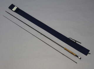 A carbon fibre 2 piece fly fishing rod in a The Rod Box blue cloth bag 