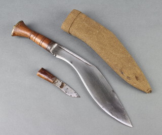 A military style Kukri with 27cm blade contained in a leather and brown cloth scabbard with 1 skinning knife 