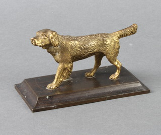 A gilt bronze paperweight in the form of a walking dog raised on a rectangular base 7cm h x 13cm w x 6cm d 