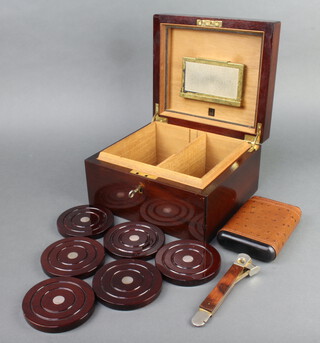 A Dunhill cedar humidor cigar box with hinged lid 13cm x 24cm x 21cm, containing 6 wooden coasters with silver centres 10cm diam., an ostrich skin cigar case and cigar cutter 
