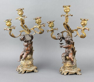 An impressive pair of 19th Century Rococo style gilt spelter 3 light candelabrum supported by cherub playing a tambourine and cherub holding a ewer of wine 43cm h x 14cm 