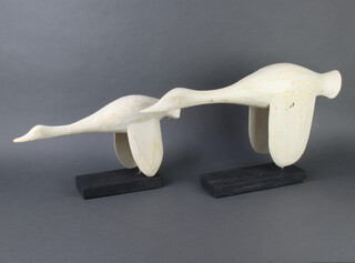 A pair of American style folk art wooden sculptures of flying geese 35cm x 57cm x 10cm and 24cm x 46cm x 11cm 