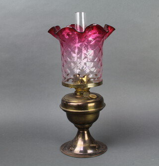 A gilt metal oil lamp with tinted glass shade and clear glass chimney 50cm h x 16cm 