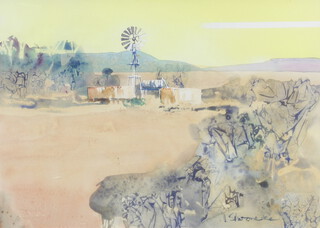 20th Century watercolour indistinctly signed, South African farmstead with water pump and distant hills 47cm x 67cm