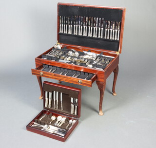 A mahogany canteen on cabriole legs containing a large quantity of silver plated cutlery for 12 (with spares)