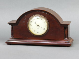 A 1930's bedroom timepiece with paper dial and Arabic numerals marked Pearce & Sons Leeds, contained in a mahogany arch shaped case, raised on bun feet 16cm h x 29cm w x 9cm d  