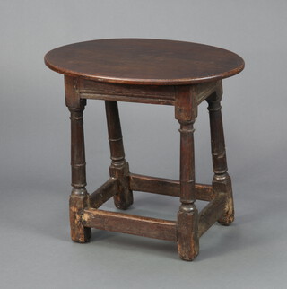 An oval oak occasional table, the bottom formed from a 17th/18th Century oak joined stool, raised on turned and block supports with later oval top 56cm h x 60cm w x 44cm d 