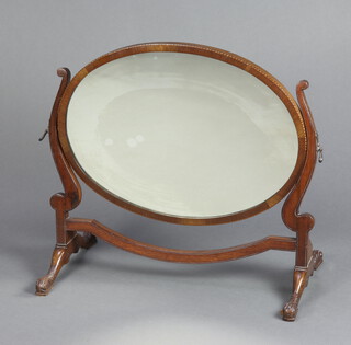 A 19th/20th Century Chippendale style oval plate dressing table mirror contained in a mahogany swing frame raised on scroll supports 60cm h x 69cm w x 35cm d 