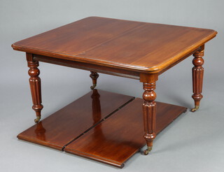 A Victorian mahogany extending dining table, raised on turned and fluted supports ending in ceramic casters 73cm h x 113cm w x 135cm l, with 2 extra leaves 231cm l, complete with winder  