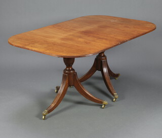 A bleached mahogany Georgian style D end dining table, raised on pillar and tripod supports, brass caps and casters 75cm h x 104cm w x 158cm d 