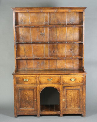 A 17th Century style oak dog kennel dresser, the raised back with moulded cornice fitted 3 shelves and 3 long drawers, the dog kennel recess flanked by a pair of cupboards 190cm h x 129cm w x 40cm d 
