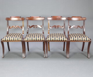 A set of 4 Regency style mahogany bar back dining chairs with carved shaped mid rails, upholstered drop in seats, raised on sabre supports 85cm h x 48cm w x 40cm d (seat 24cm x 28cm) 