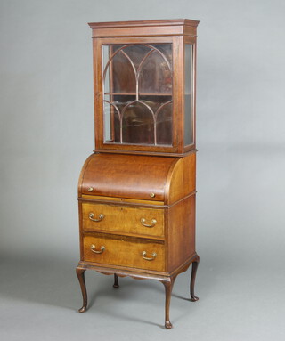 An Edwardian inlaid mahogany cylinder bureau bookcase, the upper section with moulded cornice enclosed by a astragal glazed panelled door, the cylinder revealing a fitted interior above 2 long drawers, raised on cabriole supports 176cm h x 60cm w x 46cm d 