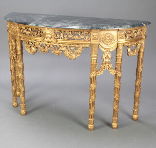 A 20th Century Empire style faux marble and gilt composition console table with green veined faux marble top, raised on a pierced base with mask decoration, raised on turned and fluted supports 90cm h x 136cm w x 51cm d 
