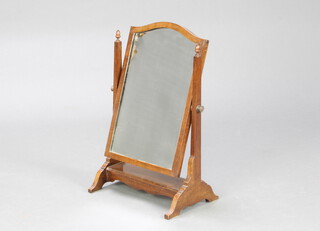 An arched plate dressing table mirror contained in a mahogany swing frame 53cm h x 33cm w x 23cm d 