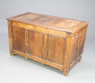 A 17th/18th Century oak coffer of panelled construction with hinged lid 64cm h x 112cm w x 65cm d 