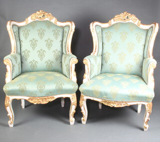 An impressive pair of French style white and gilt painted armchairs upholstered in green and gold material 120cm h x 74cm w x 48cm d (seat 38cm x 38cm) 