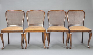 A set of 4 1920's French walnut Queen Anne style dining chairs with woven cane backs and upholstered drop in seats, raised on cabriole supports 87cm h x 49cm w x 46cm d (seat 28cm x 30cm) 
