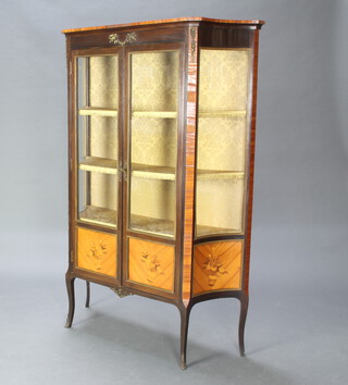 A French style Kingwood display cabinet of serpentine outline, fitted shelves enclosed by glazed panelled doors with gilt mounts throughout 158cm h x 100cm w x 35cm d 